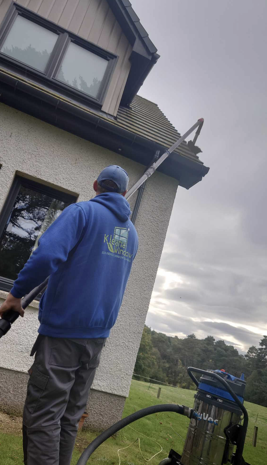 Professional gutter cleaning service in Inverness - Kleana Window team member cleaning gutters